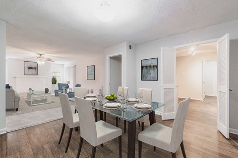 an open living room and dining room with a table and chairs